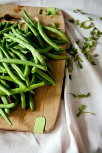 green beans on a cutting board for the whole chicken recipe